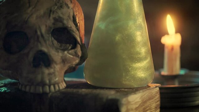 magic potion and skull on top of a spooky book