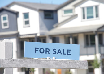 Close up on For Sale sign in front of a California Home. Housing crisis, homes for sale..