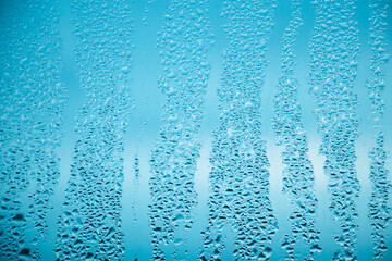Texture of misted glass in autumn. Drops of water on window in rainy weather. Abstract background.