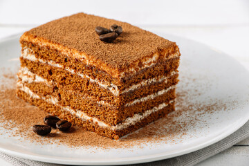 Traditional Italian dessert tiramisu on light background.