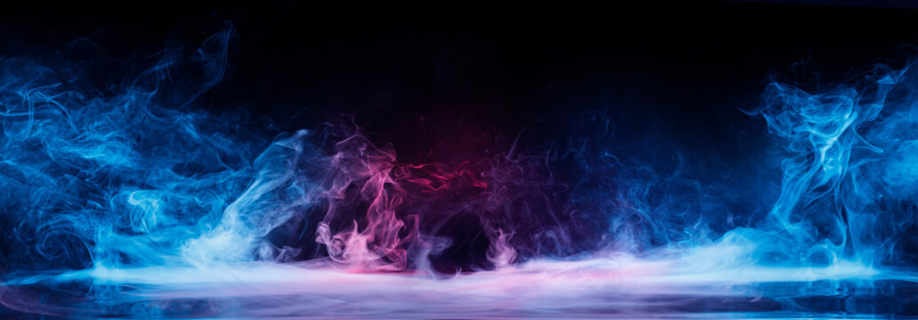 Panoramic view of the abstract fog. Red and blue cloudiness, mist or smog moves on black background. Beautiful swirling blue smoke. Mockup for your logo. Wide angle horizontal wallpaper or web banner.