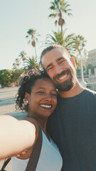 Fototapeta premium Close-up of interracial smiling couple in love taking selfie