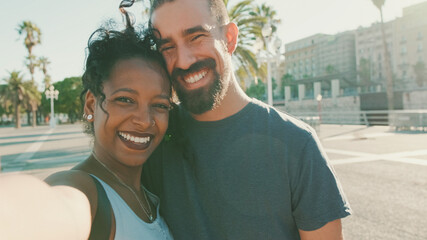 Fototapeta na wymiar Close-up of interracial smiling couple in love taking selfie