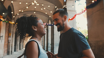 Happy interracial couple dancing outdoors