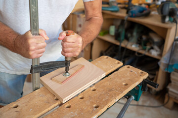 Senior carpenter working on wood craft. Professional tools for crafting. DIY maker and carpentry work concept.