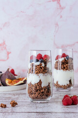 granola in a glass with Greek yogurt and wild berries