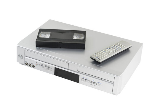 Old video cassette and disk player with tape and remote controller isolated.