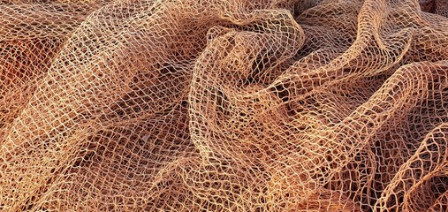 Fishing nets for catching fish in the sea and ocean. Fishing nets on a ship. Texture of fishing...