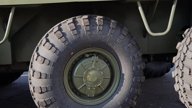 Close-up of a military APC leaving the hangar. shooting details of military equipment