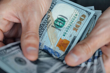 hand holding 100 dollar bank notes detail for business and financial use, news, article, blog