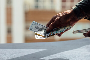 hand holding 100 dollar bank notes detail for business and financial use, news, article, blog