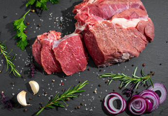 fresh cut meat close-up with spices on a dark background