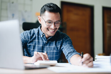 Fototapeta premium financial, Planning, Marketing and Accounting, portrait of Asian woman Economist using calculator to calculate investment documents with partners on profit taking to compete with other companies