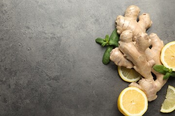 Fresh lemon, ginger and mint on grey table, flat lay. Space for text
