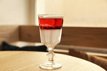 Delicious panna cotta dessert with berries on wooden table