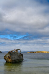 Fototapeta na wymiar Falkland Islands, weathered wooden ship in bay of New Island