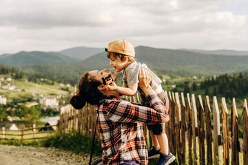 Raising children in harmony and love for nature. Journey of a young woman with a baby in the mountains in summer.