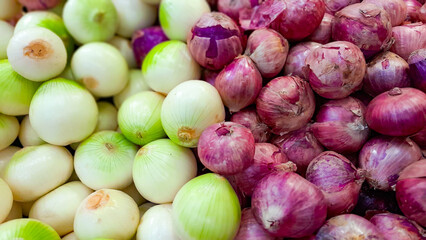 pile of onions on the shelf of the super market