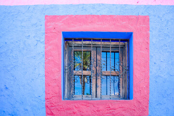 Fototapeta na wymiar Cabo San Lucas, Mexico. Colorful wall and window.