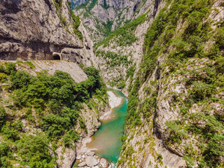 The purest waters of the turquoise color of the river Moraca flowing among the canyons. Travel around Montenegro concept Portrait of a disgruntled girl sitting at a cafe table