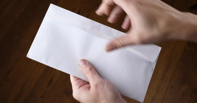 hand opens a white envelope with an empty blank. High quality 4k footage