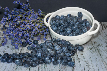  Bouquet of fresh lavender and freshly picked blueberries  on the tree bark background