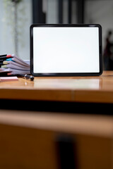 Blank screen digital tablet on wooden table, vertical view. Mockup creative workspace with digital tablet.