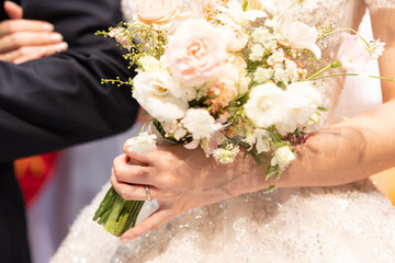 Bride and groom together, and holding the wedding bouquet