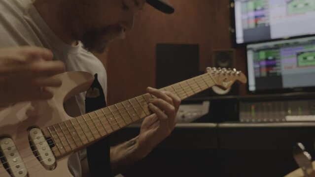 Man Playing Electric Guitar in Studio