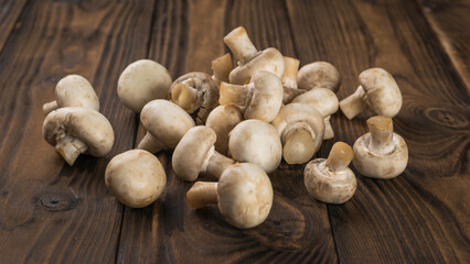 A bunch of fresh mushrooms on a rustic background.