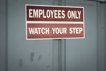 Employees only and watch your step sign