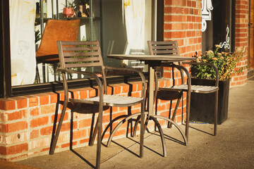 Table and chair on outdoor patio of brick building