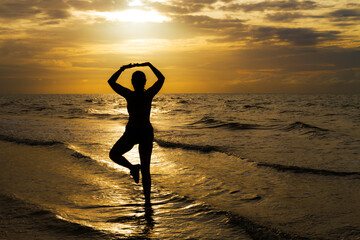 Fototapeta na wymiar Woman with swimsuit and silhouette exercise at beach