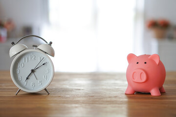 piggy bank coin save salary money for retie and clock at home blur background, save money for retiement concept