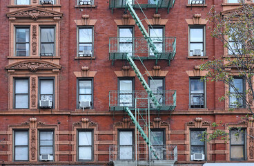 Old fashioned New York apartment building .with ornate window frames and exterior fire escape