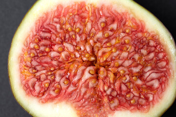 Figs cut into pieces on a black background close-up