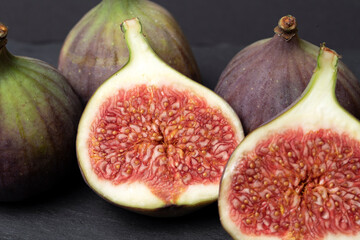 Figs cut into pieces on a black background close-up