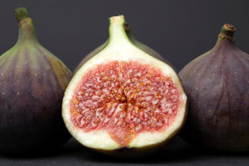 Figs cut into pieces on a black background close-up