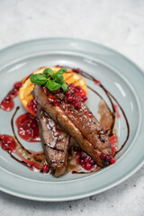 Tasty duck breast with orange and berries