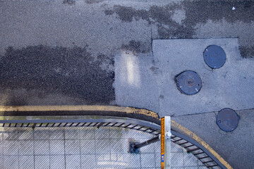 overhead street corner concrete road sewer lid composition