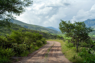 landscape of dirt road with andes mountains in loja ecuador during golden hour