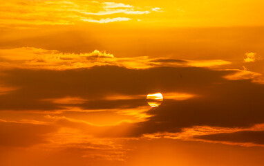 Telephoto photo of yellow orange sunset sunrise, clouds, sky golden hour. golden