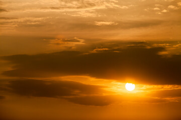 Fototapeta na wymiar Telephoto photo of yellow orange sunset sunrise, clouds, sky golden hour. golden