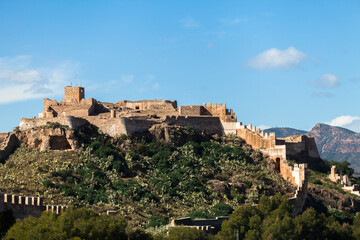 Fototapeta premium castle of sagunt in spain with port city and ocean background