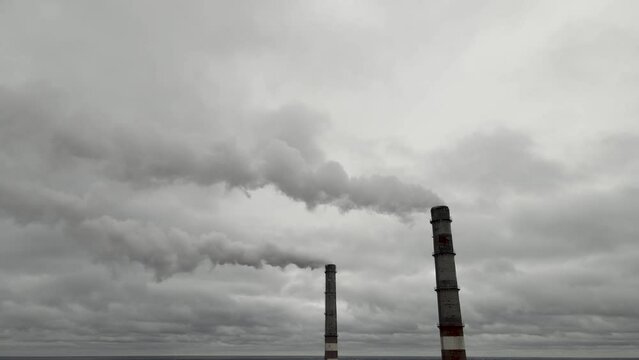 Atmospheric pollution,harmful emissions and global warming,ecological problem.Smoky chimneys of the power plant aerial view.Electric power generation,power plant for burning coal.Thick smoke from fuel