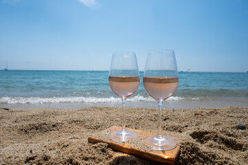 Cold rose wine from Provence served outdoor on white sandy beach Plage de Pampelonne near Saint-Tropez, France