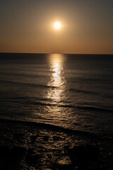Fototapeta premium Sunset in calm waters of Atlantic ocean and clear sky