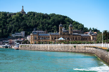 Walking near La Concha sandy beach in San Sebastian or Donostia city, touristic destination in Basque Country, north of Spain
