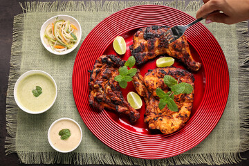 Thandoori chicken , Arabian spicy food tandoori whole chicken Bengaluru, India . Platter served with salads. Al Faham Charcoal Grilled Chicken in India .