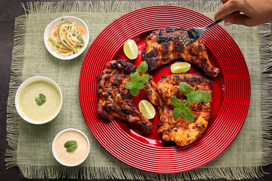 Thandoori chicken , Arabian spicy food tandoori whole chicken Bengaluru, India . Platter served with salads. Al Faham Charcoal Grilled Chicken in India .